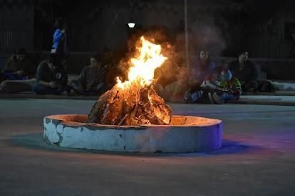 Bonfire circle with guests at night
